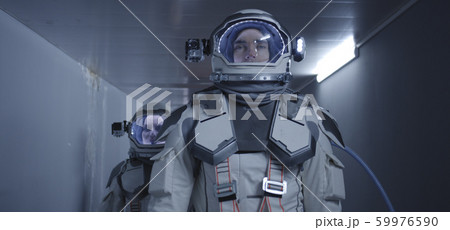 Astronauts walking down a corridor 59976590