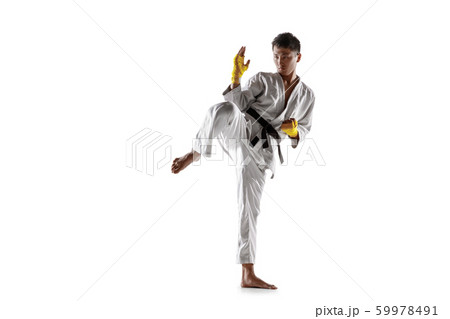 Confident korean man in kimono practicing hand-to-hand combat, martial arts Confident korean man in kimono practicing hand-to-hand combat, martial arts 59978491