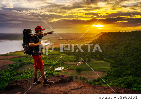 man traveler with backpack standing on edge of man traveler with backpack standing on edge of 59980301