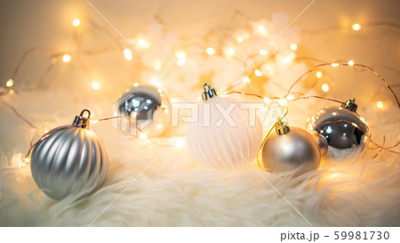 Christmas ball on hairy carpet with festive lights Christmas ball on hairy carpet with festive lights 59981730