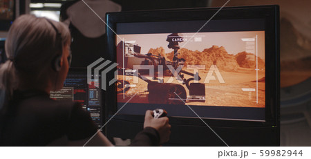 Woman controlling Mars rover with remote controller 59982944