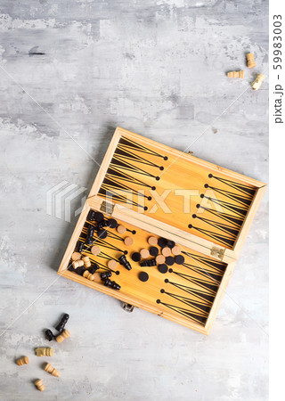 backgammon dice and pieces with a pair of chess pieces on the stone background, flat lay backgammon dice and pieces with a pair of chess pieces on the stone background, flat lay 59983003