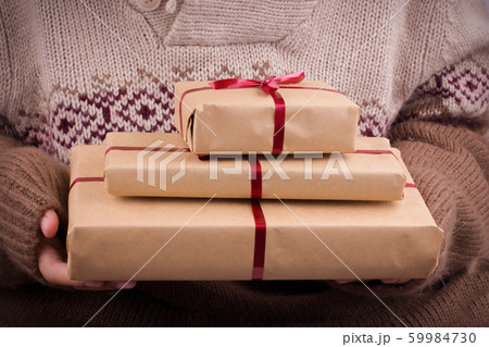 Gift boxes with red ribbon in the hands. Hands Gift boxes with red ribbon in the hands. Hands 59984730