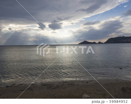 dramatic sky with sun rays from clouds on sea dramatic sky with sun rays from clouds on sea 59984952