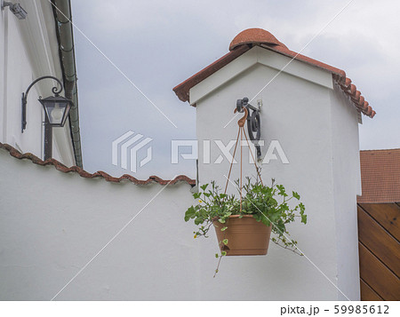Decorative hanging flower pot in front of old Decorative hanging flower pot in front of old 59985612