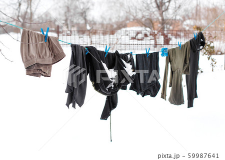 Winter. Clothes are drying on the street. Clothes Winter. Clothes are drying on the street. Clothes 59987641