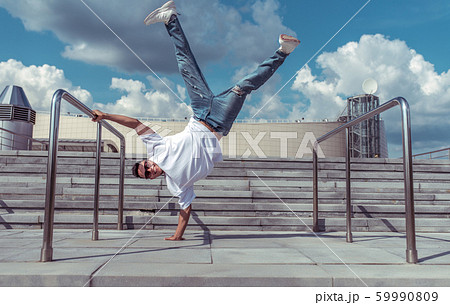 Male Athlete Standing On One Arm Summer City の写真素材
