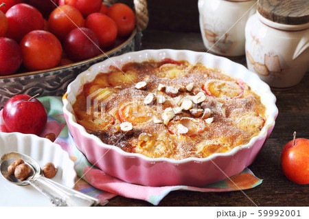 Autumn dessert. Red plums clafoutis, hazelnut and Autumn dessert. Red plums clafoutis, hazelnut and 59992001