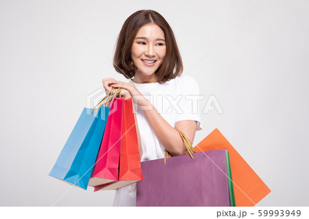 Shopping Asian woman with short hairs smile and Holding Shopping bags, Cheerful and happiness emotional, Enjoy Shopping in black friday sale, Isolated on gray background, Shopping Concept Shopping Asian woman with short hairs smile and Holding Shopping bags, Cheerful and happiness emotional, Enjoy Shopping in black friday sale, Isolated on gray background, Shopping Concept 59993949