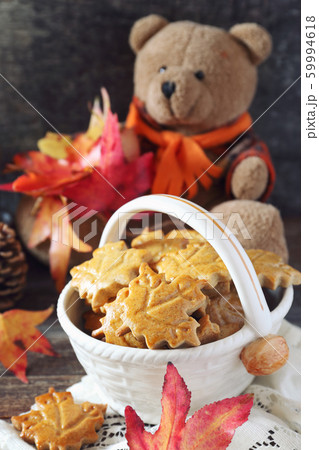 Autumn mood: cinnamon cookies in form of maple leaves, red leaves and Teddy bear Autumn mood: cinnamon cookies in form of maple leaves, red leaves and Teddy bear 59994618