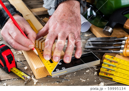 Craftsman at work on wooden boards. Carpentry. 59995134