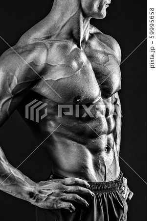 Beautiful naked male torso against black background 59995658