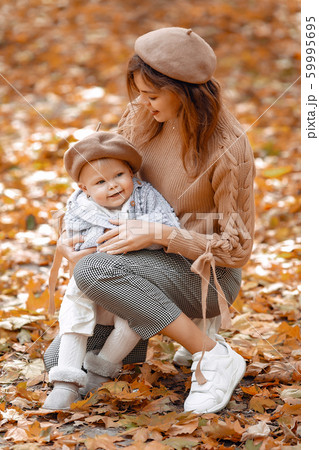 Cute and stylish family in a autumn park 59995695