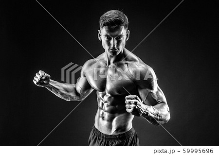 bodybuilder posing. Beautiful sporty guy male power. Fitness muscled man bodybuilder posing. Beautiful sporty guy male power. Fitness muscled man 59995696