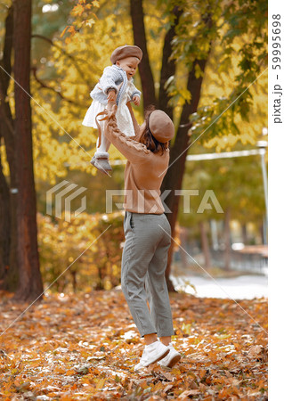 Cute and stylish family in a autumn park 59995698
