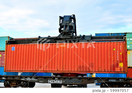 Shipping container loading by richtracker on the freight rail car  59997057