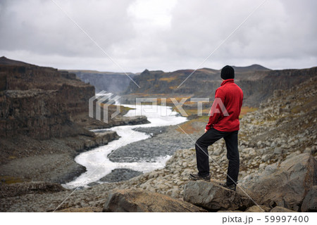 Hiker standing at the edge of a Valley in Vatnajokull National Park in Iceland Hiker standing at the edge of a Valley in Vatnajokull National Park in Iceland 59997400