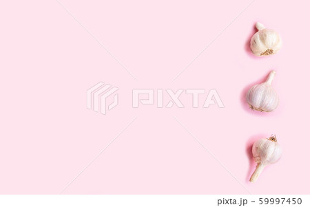 Three heads of fresh garlic on a pink background, Three heads of fresh garlic on a pink background, 59997450