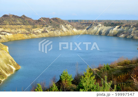Artificial lake was is formed after the extraction of chalk in an industrial quarry Artificial lake was is formed after the extraction of chalk in an industrial quarry 59997547