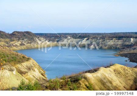 Artificial lake was is formed after the extraction of chalk in an industrial quarry Artificial lake was is formed after the extraction of chalk in an industrial quarry 59997548