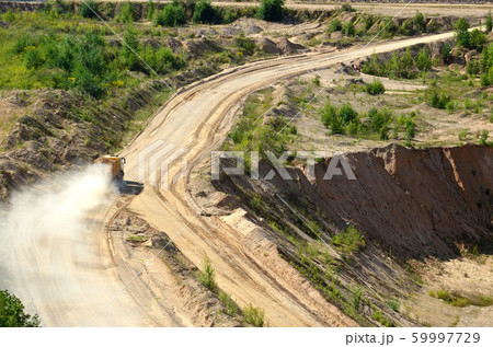 Dump truck transports sand and other minerals in the mining quarry. 59997729