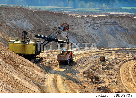 Quarry excavator loading sand or into dump truck 59998705