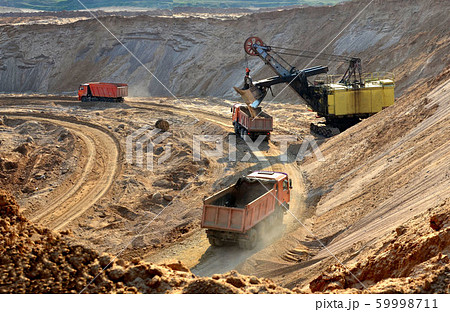 Quarry excavator loading sand or into dump truck 59998711