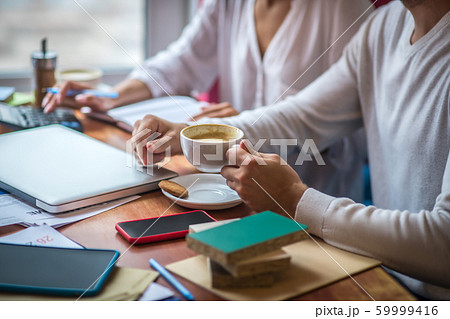 Interior designer drinking cappuccino while sitting near wife 59999416