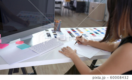 Creative designer drawing and sketching new ideas on paper in the office 60008432