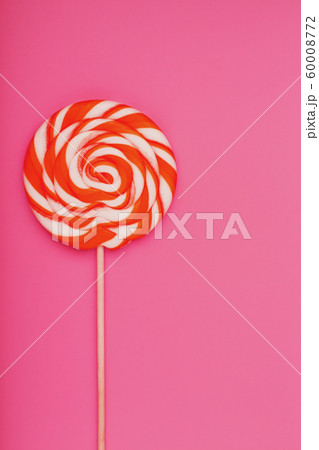Orange Lollipop on a pink background with a soft Orange Lollipop on a pink background with a soft 60008772