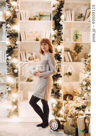 Beautiful woman in grey dress with Christmas 60009119