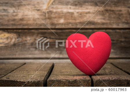 Red heart on the weathered wooden background 60017963