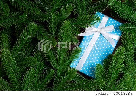 Top view of festive gift box decorated with green Top view of festive gift box decorated with green 60018235