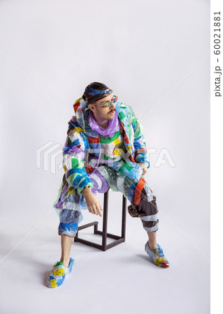Man addicted of sales and clothes, wearing plastic, recycling concept Man addicted of sales and clothes, wearing plastic, recycling concept 60021881
