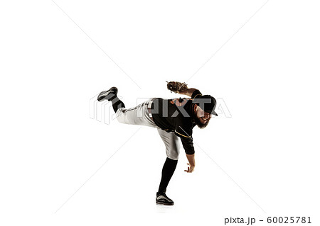 Baseball player, pitcher in a black uniform practicing on a white background. Baseball player, pitcher in a black uniform practicing on a white background. 60025781
