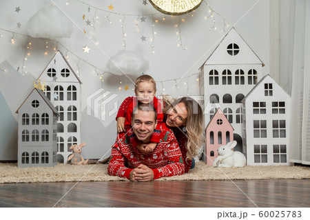 Beautiful happy family of three in a New Year's 60025783
