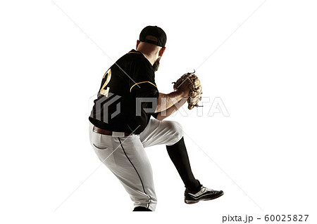 Baseball player, pitcher in a black uniform practicing on a white background. Baseball player, pitcher in a black uniform practicing on a white background. 60025827