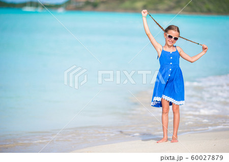 Portrait of beautiful girl on the beach dancing Portrait of beautiful girl on the beach dancing 60027879