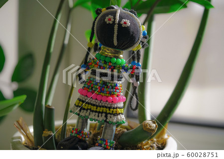 Souvenir from South Africa, doll in a traditional national dress made of beads. Horizontal image 60028751