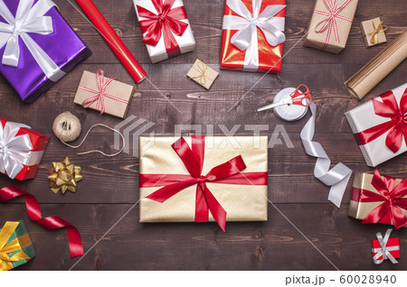 Christmas presents on wooden table Christmas presents on wooden table 60028940