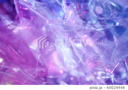 Holographic background in the style of the 80-90s. Real texture of cellophane film in bright acid colors. Holographic background in the style of the 80-90s. Real texture of cellophane film in bright acid colors. 60029498