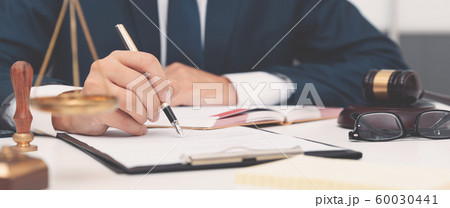 Lawyer or attorney working with papers in office 60030441