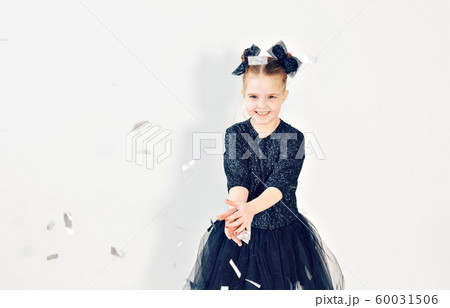 Party, holidays, new year and celebration concept - Female child throwing confetti. Party, holidays, new year and celebration concept - Female child throwing confetti. 60031506