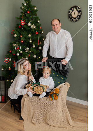 Beautiful happy family at the New Year tree. Beautiful happy family at the New Year tree. 60031983