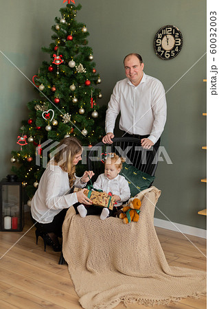 Beautiful happy family at the New Year tree. 60032003