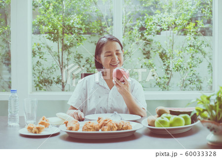 Senior asian woman hands holding apple fresh fruit at home,Elderly healthy food concept 60033328