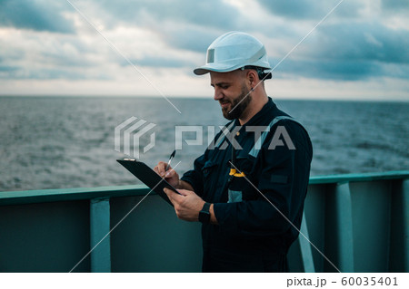Deck Officer on deck of offshore vessel or ship , wearing PPE personal protective equipment Deck Officer on deck of offshore vessel or ship , wearing PPE personal protective equipment 60035401