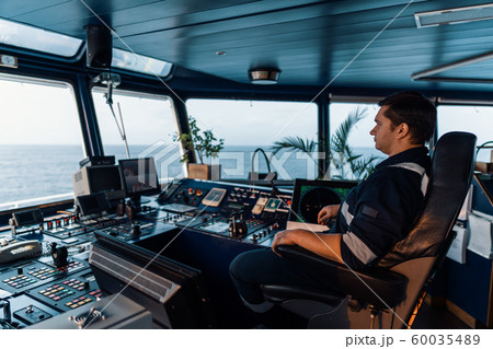 Marine navigational officer during navigational watch on Bridge . Work at sea 60035489