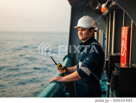 Marine Deck Officer or Chief mate on deck of offshore vessel or ship , wearing PPE personal Marine Deck Officer or Chief mate on deck of offshore vessel or ship , wearing PPE personal 60035495