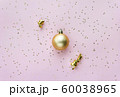 Christmas sparkles composition. Christmas ball and golden stars on pastel pink background. 60038965